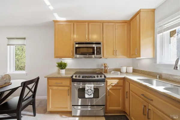 a kitchen with a stove a sink and a microwave