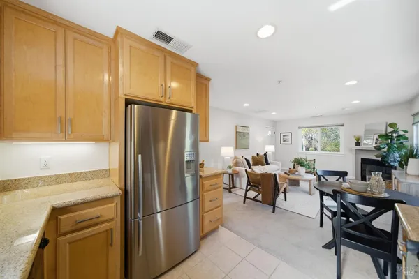 a kitchen with stainless steel appliances a refrigerator and dining table