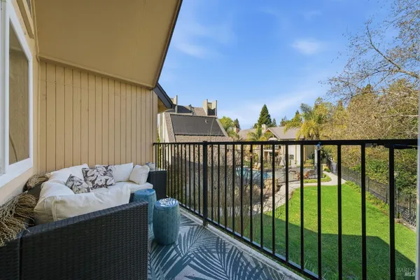 a view of a balcony with furniture