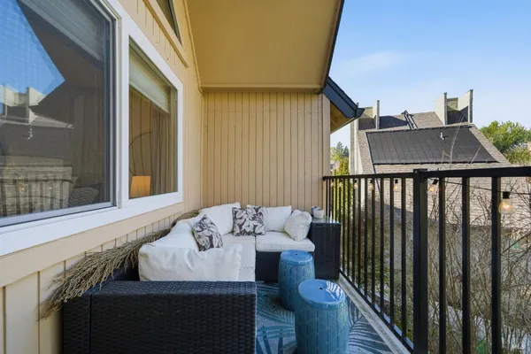 a balcony with table and chairs