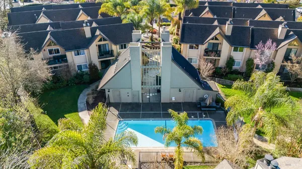 an aerial view of residential houses with yard and swimming pool