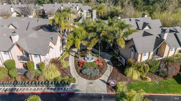 an aerial view of a house with garden space and street view