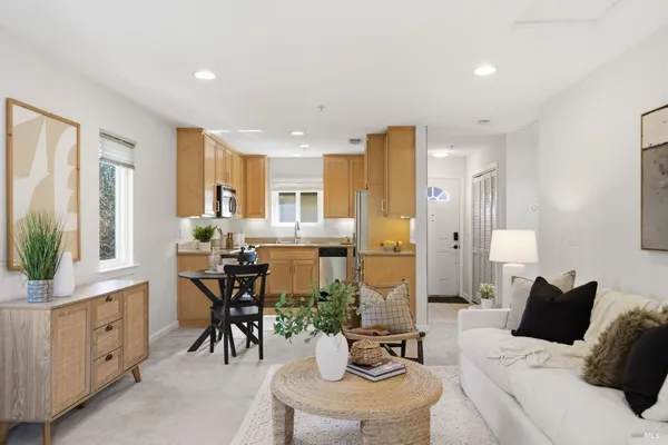 a living room with furniture a dining table and chairs