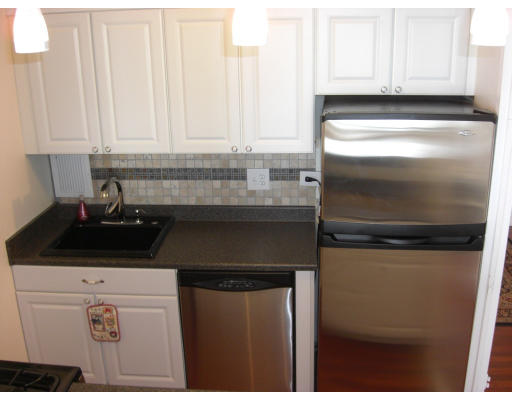 65 East India Row, Unit 16E Boston, MA 02110 - Photo 2 of 11 a kitchen with a sink and cabinets