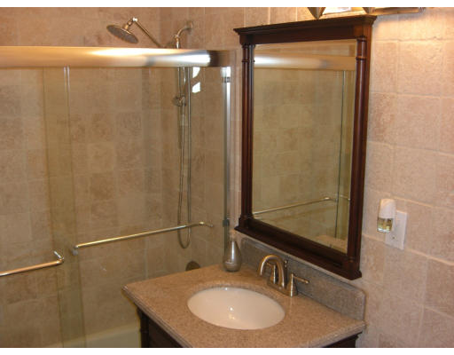 65 East India Row, Unit 16E Boston, MA 02110 - Photo 4 of 11 a bathroom with a sink and mirror