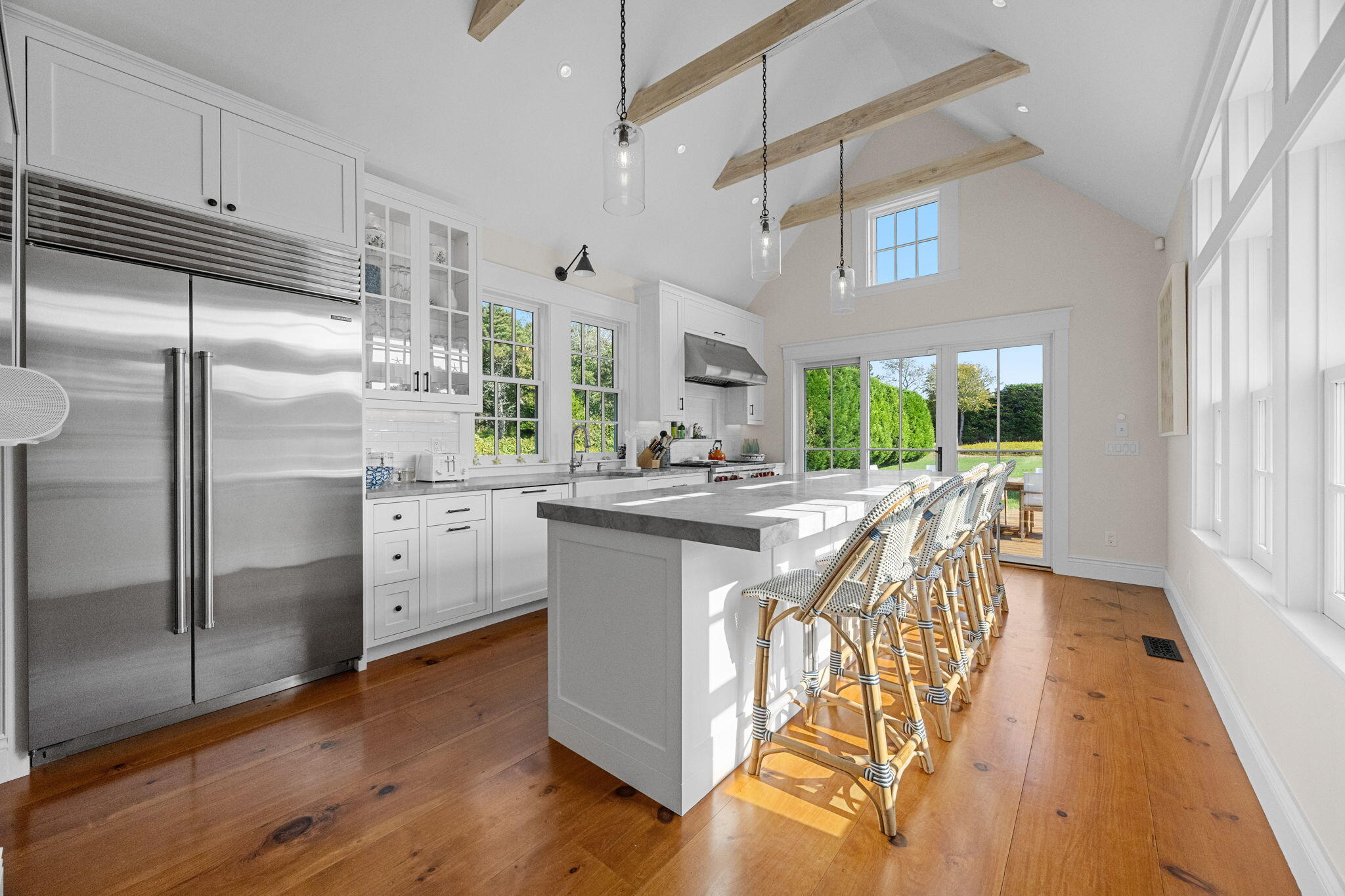 85 Cedar Street Chatham, MA 02633 - Photo 22 of 89 a kitchen with stainless steel appliances granite countertop a refrigerator a sink dishwasher a stove and white cabinets with wooden floor