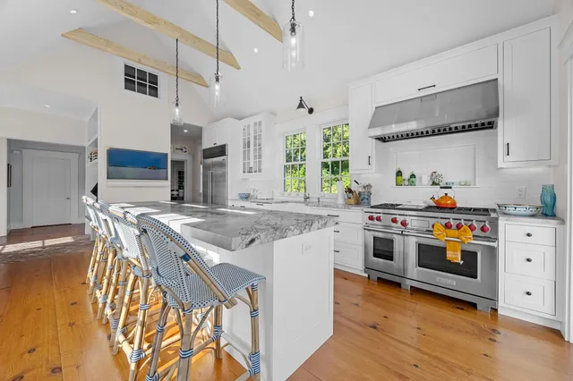 a bedroom with two beds and painting on the wall