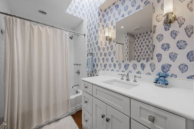 a view of an apartment with a garden and trees