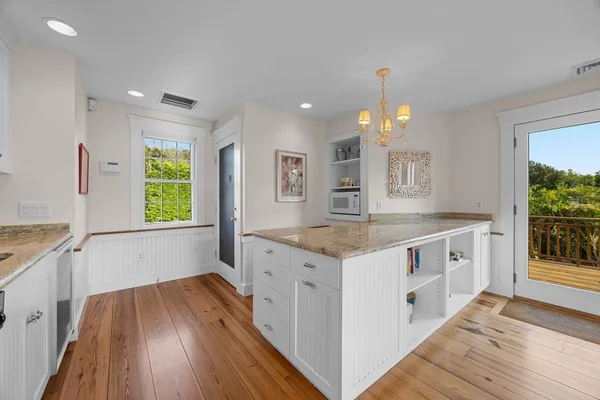 an aerial view of residential houses with outdoor space and trees