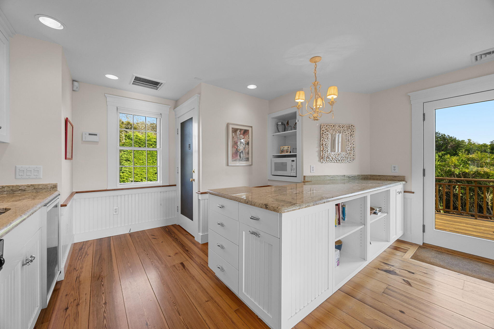 85 Cedar Street Chatham, MA 02633 - Photo 46 of 89 a kitchen with granite countertop a white stove top oven sink and wooden floor