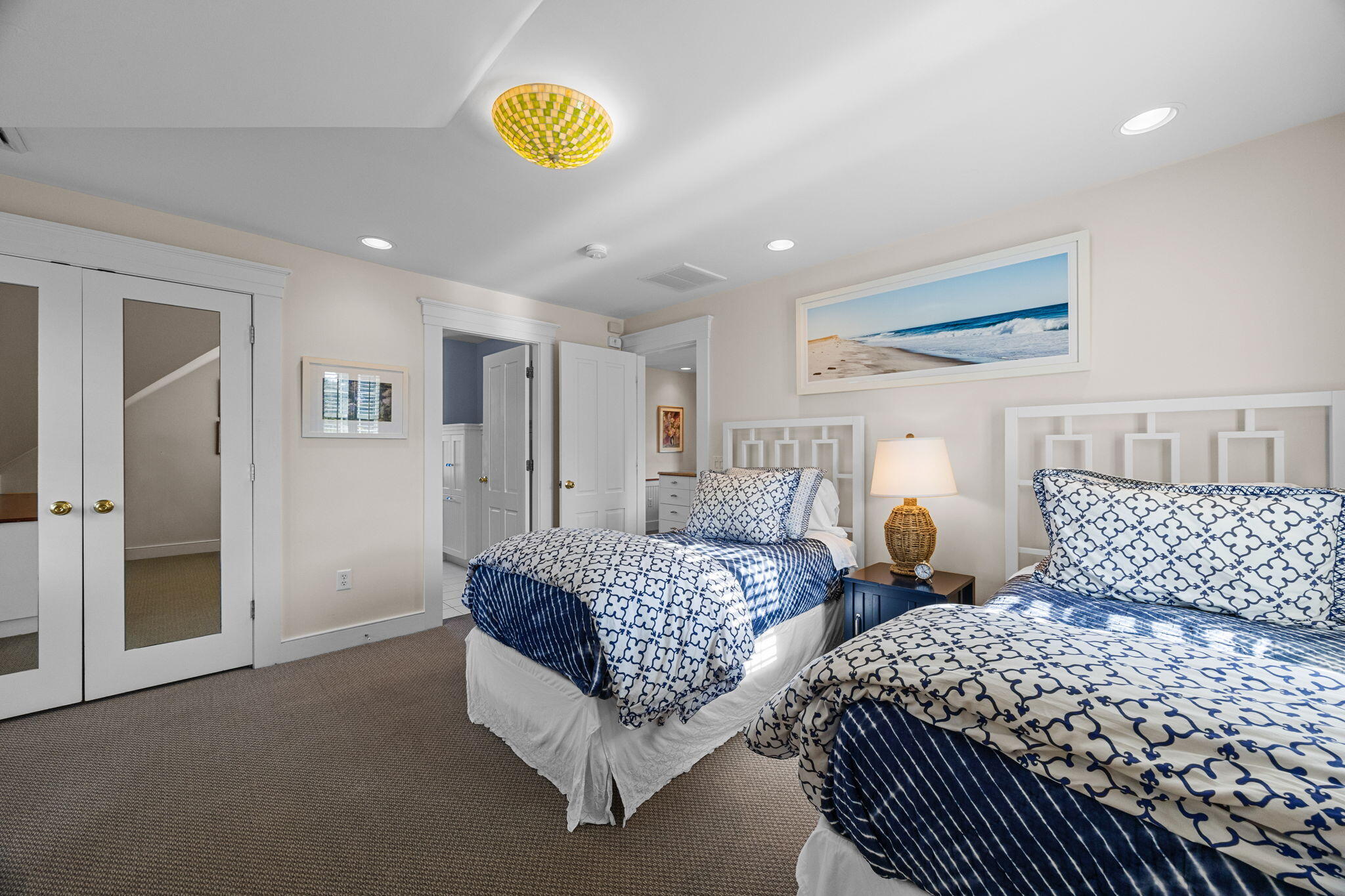 85 Cedar Street Chatham, MA 02633 - Photo 53 of 89 a spacious bedroom with two beds and a chandelier