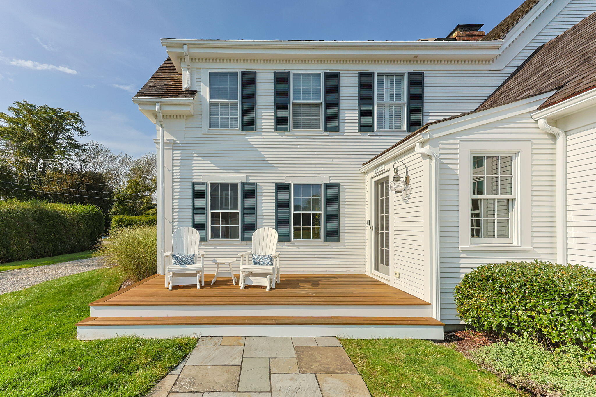 85 Cedar Street Chatham, MA 02633 - Photo 59 of 89 a front view of a house with a yard table and chairs