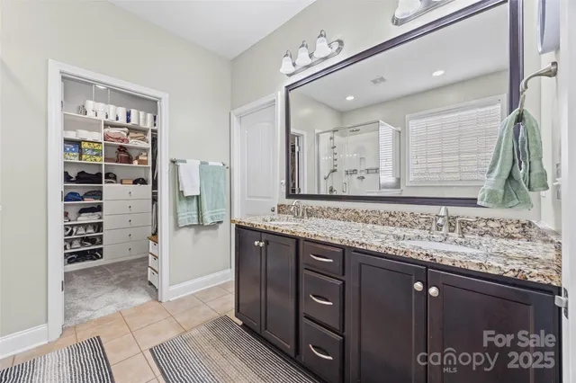 a bathroom with a granite countertop sink a toilet and a mirror