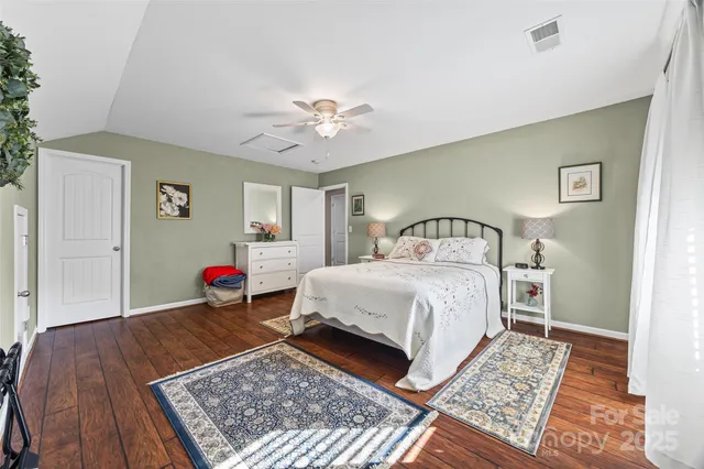 a bedroom with a bed rug and a window