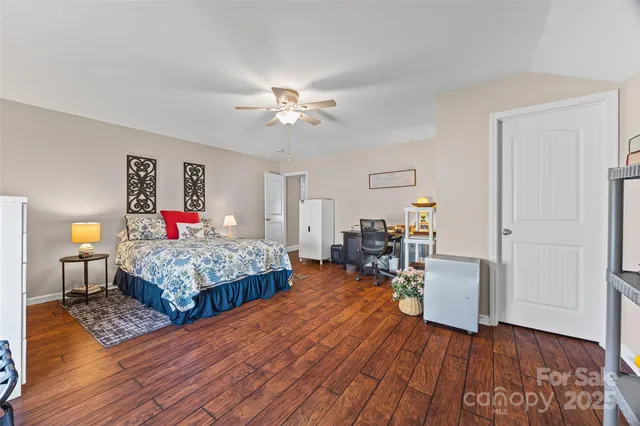 a bedroom with furniture and a wooden floor