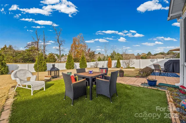a view of a backyard with sitting area