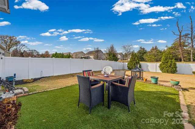 a view of a patio with table and chairs