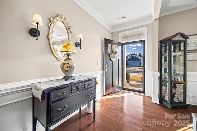 a view of living room with furniture and wooden floor
