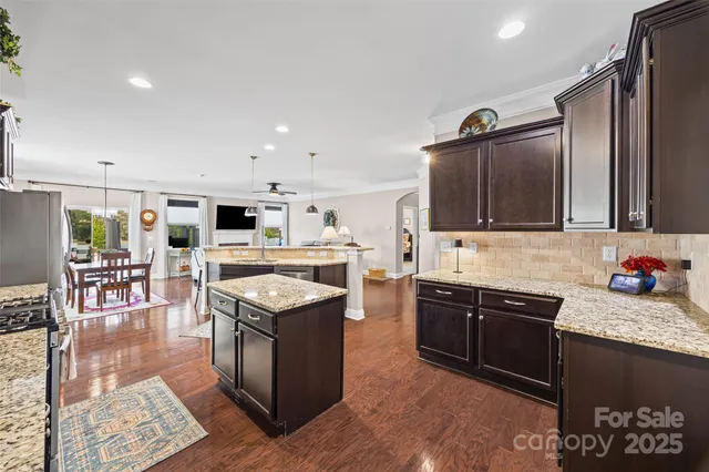 a kitchen with granite countertop stainless steel appliances and wooden cabinets