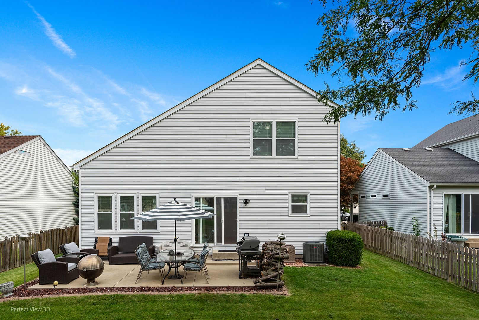 5802 Emerald Pointe Drive Plainfield, IL 60586 - Photo 2 of 28 a backyard of a house with table and chairs