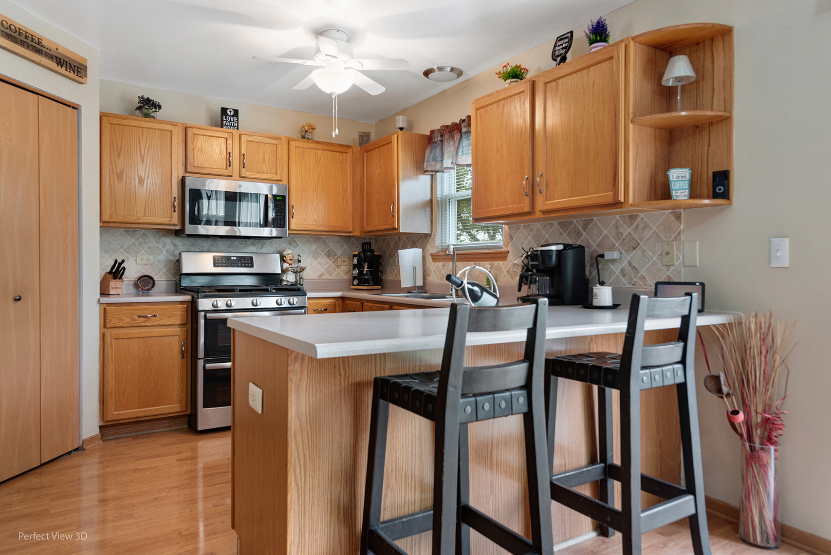 5802 Emerald Pointe Drive Plainfield, IL 60586 - Photo 6 of 28 a kitchen with stainless steel appliances granite countertop a stove a sink a microwave a refrigerator and cabinets