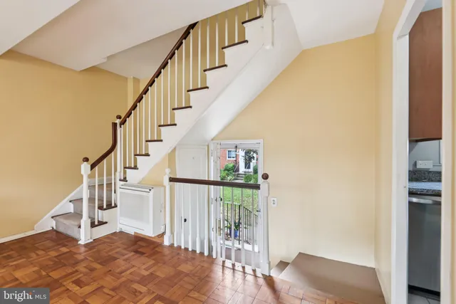a view of entryway and hall with wooden floor