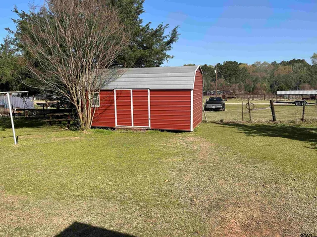 a view of a backyard with a large tree