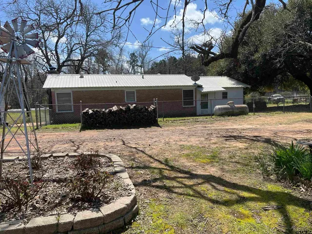 a view of a house with a yard covered in snow