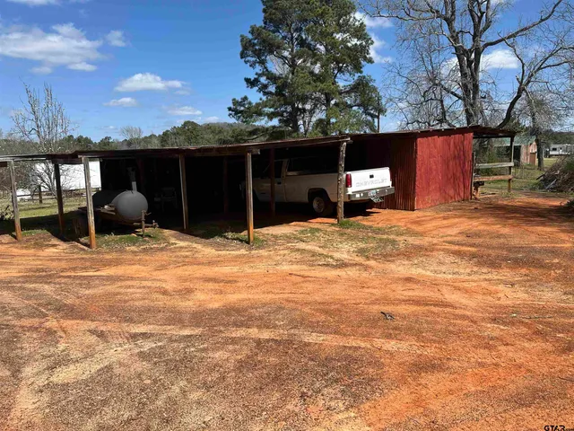 a view of a backyard with couches and a fire pit