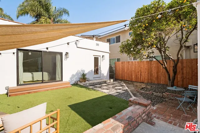 a view of a backyard with a large tree