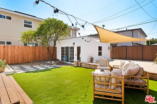 a backyard of a house with yard and outdoor seating