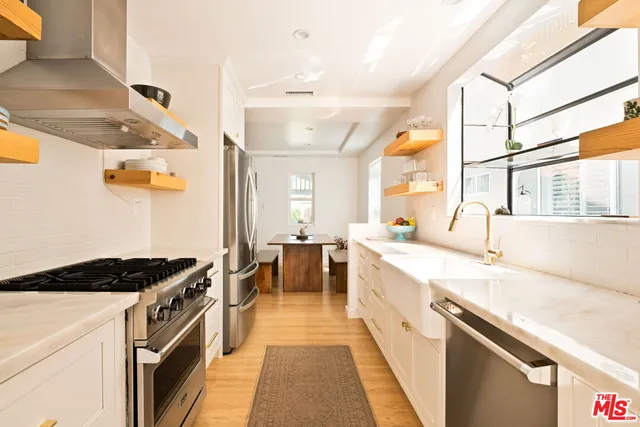 a kitchen with a sink stove and cabinets