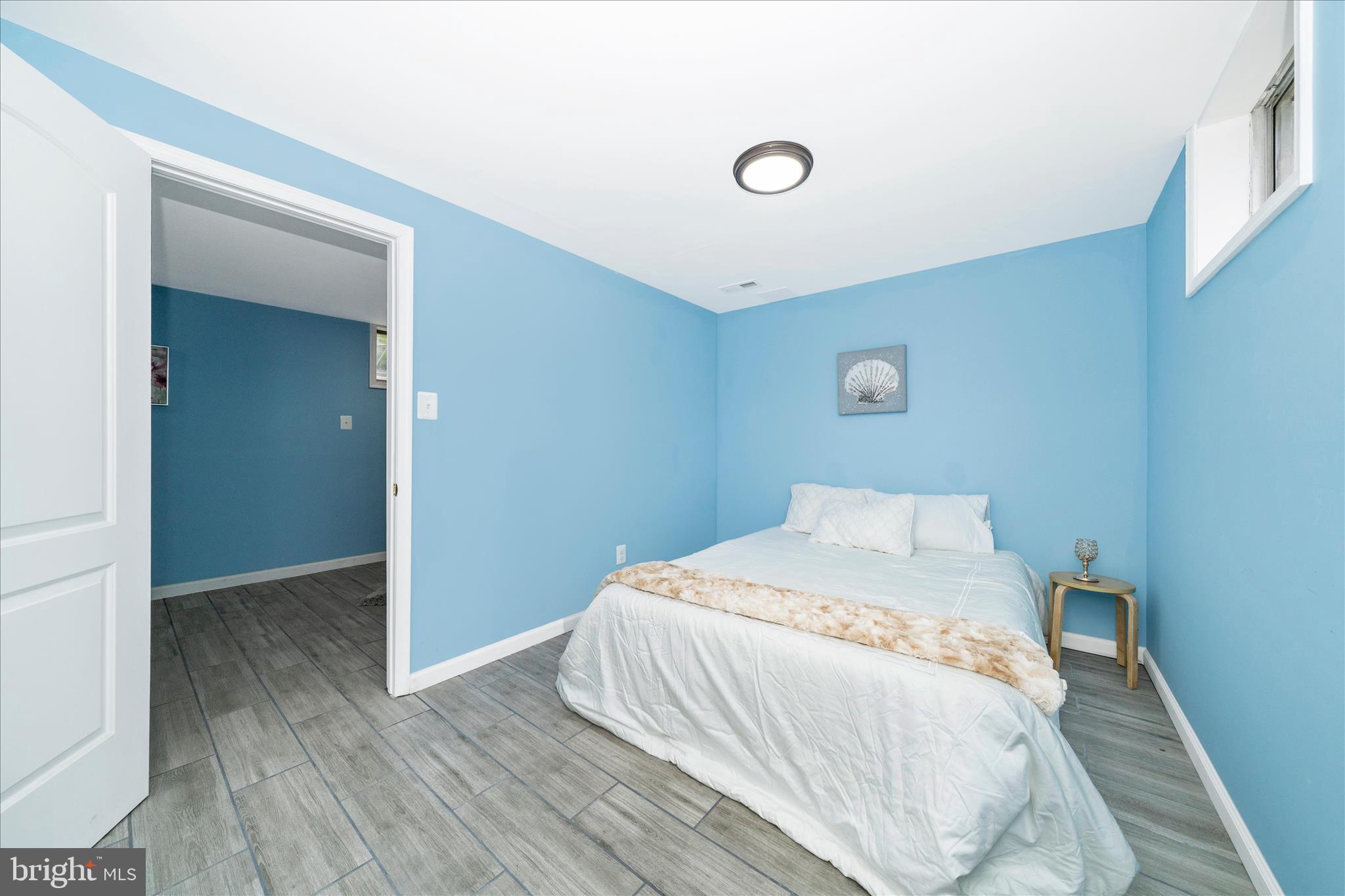 713 Seek Lane Silver Spring, MD 20912 - Photo 36 of 60 a bedroom with a bed and wooden floor