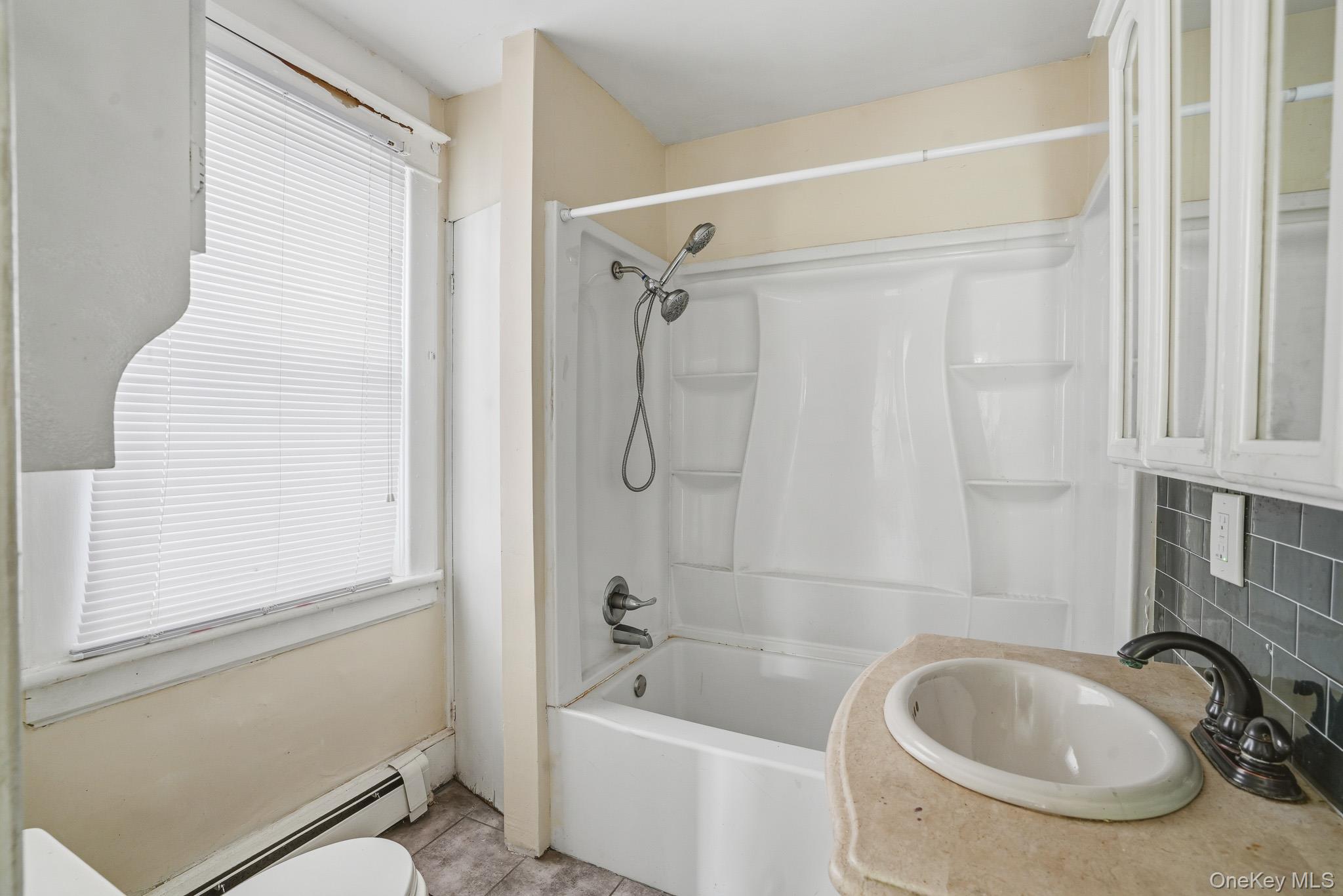 65 North Clinton Street Poughkeepsie, NY 12601 - Photo 18 of 43 a bathroom with a sink a toilet and a bathtub