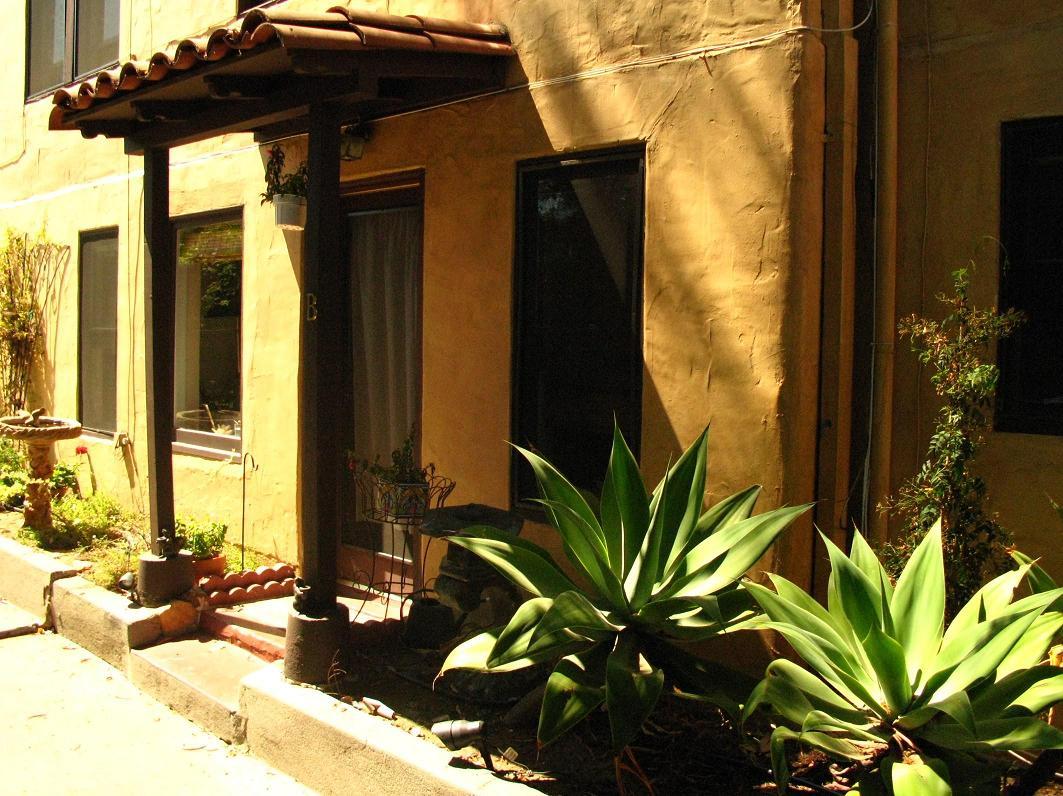 1423 Alta Vista Road Santa Barbara, CA 93103 - Photo 13 of 17 a vase of flowers sitting on a table in front of a house