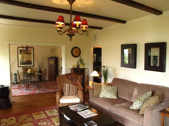 1423 Alta Vista Road Santa Barbara, CA 93103 - Photo 5 of 17 a living room with couches a dining table and chairs with chandelier