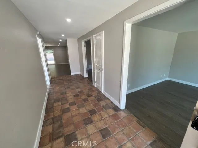 a view of a room with wooden floor and window