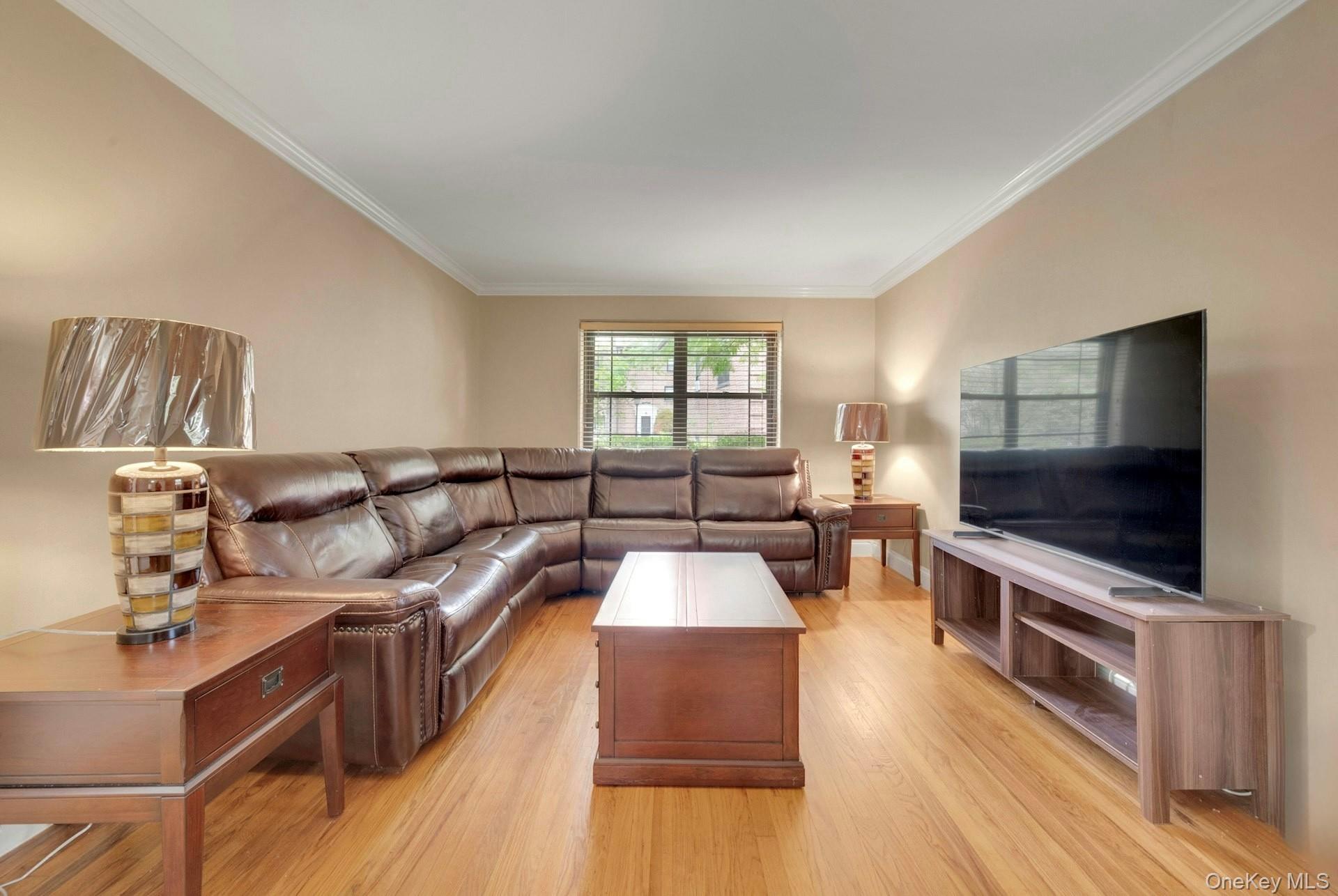 6 Manchester Road, Unit 1 Eastchester, NY 10709 - Photo 13 of 40 Living area featuring ornamental molding and light wood finished floors