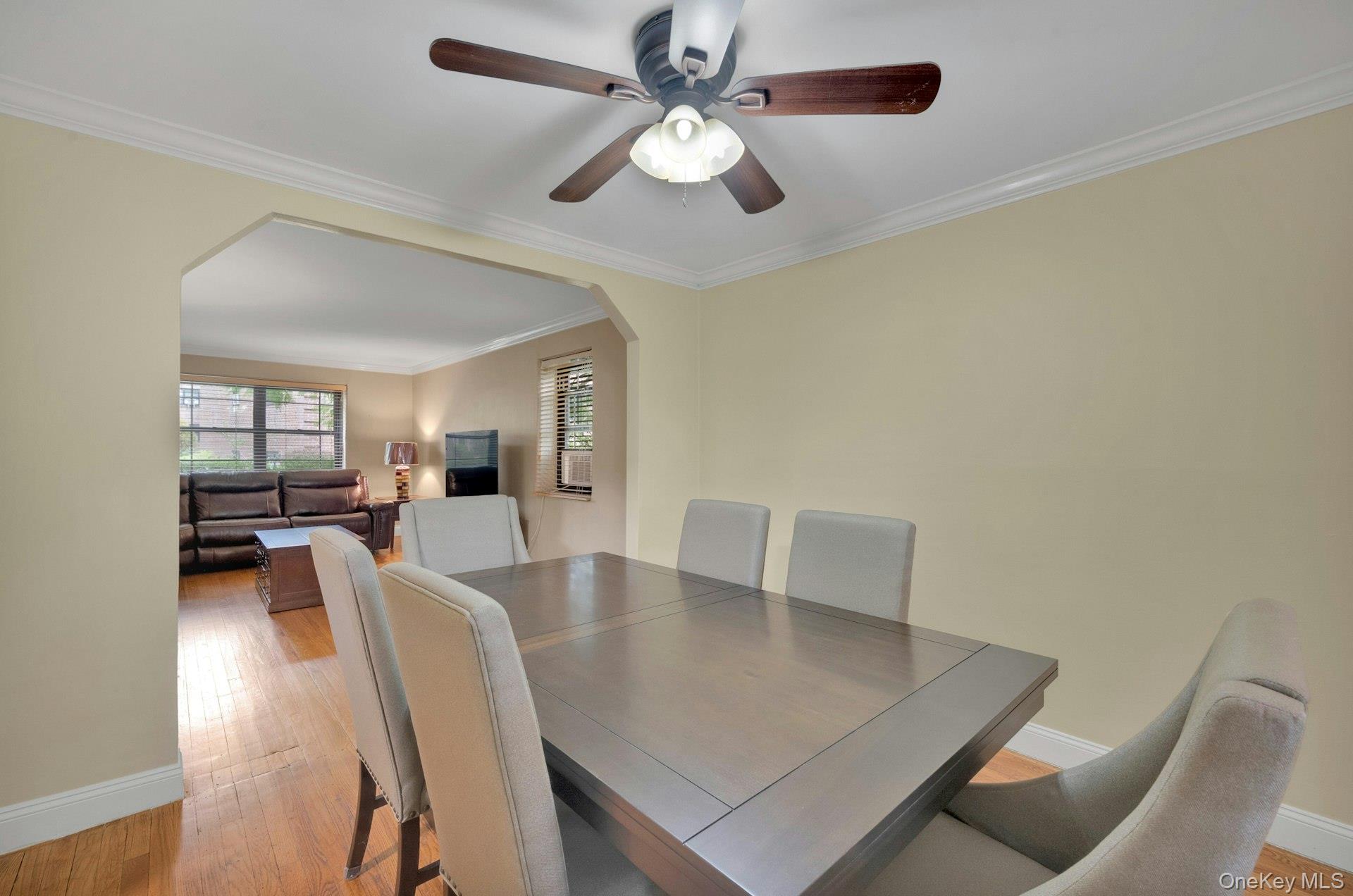 6 Manchester Road, Unit 1 Eastchester, NY 10709 - Photo 16 of 40 Dining space with arched walkways, light wood-style floors, and ornamental molding