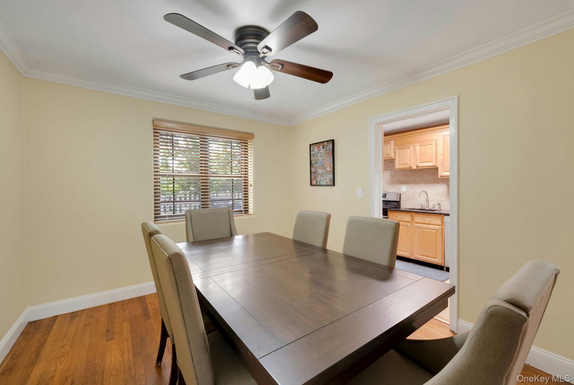 6 Manchester Road, Unit 1 Eastchester, NY 10709 - Photo 18 of 40 Dining space with crown molding, light wood-style flooring, and ceiling fan