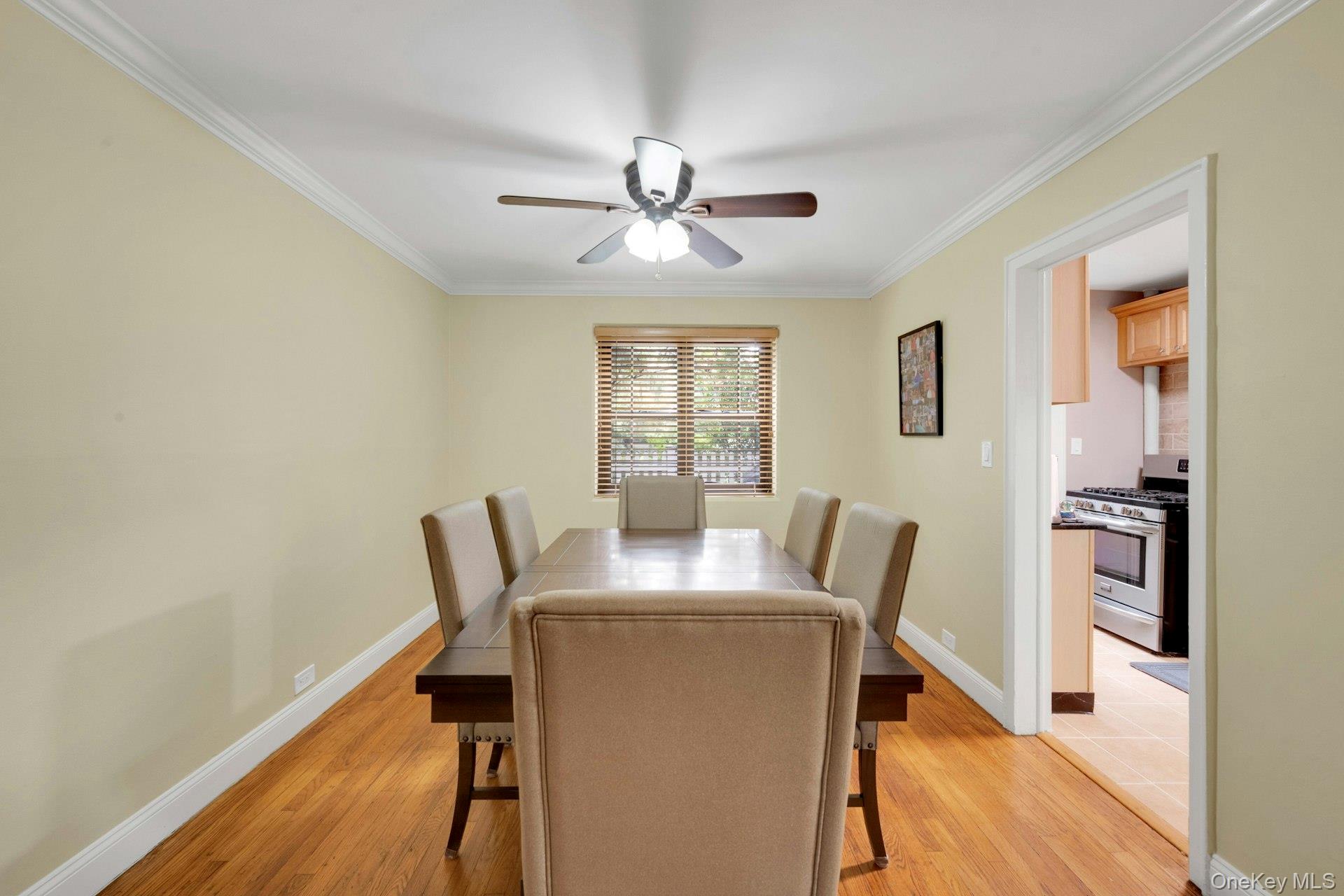 6 Manchester Road, Unit 1 Eastchester, NY 10709 - Photo 19 of 40 Dining area with ornamental molding, light wood-style flooring, and ceiling fan