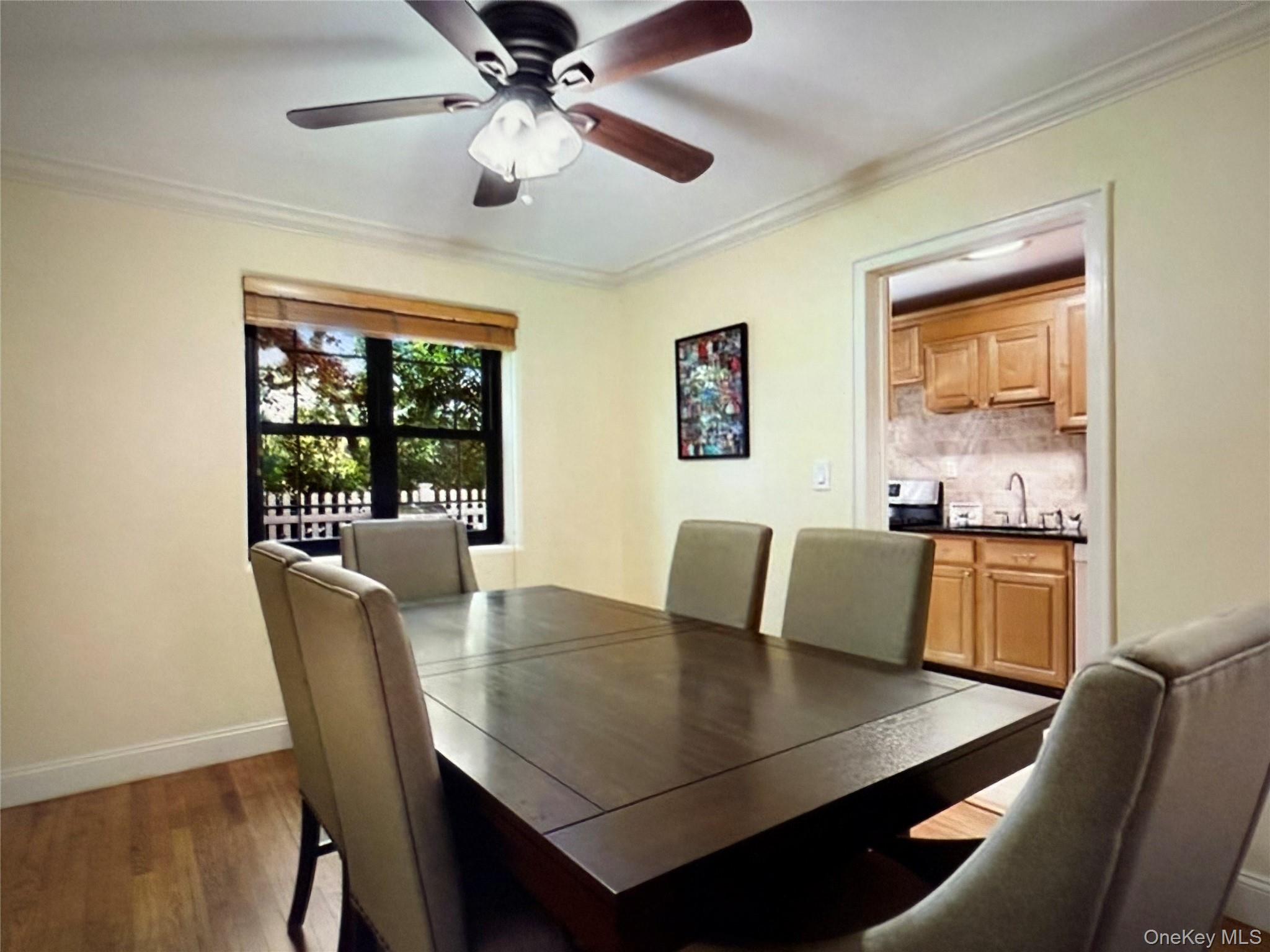6 Manchester Road, Unit 1 Eastchester, NY 10709 - Photo 20 of 40 Dining area featuring ornamental molding, dark wood-style flooring, and ceiling fan