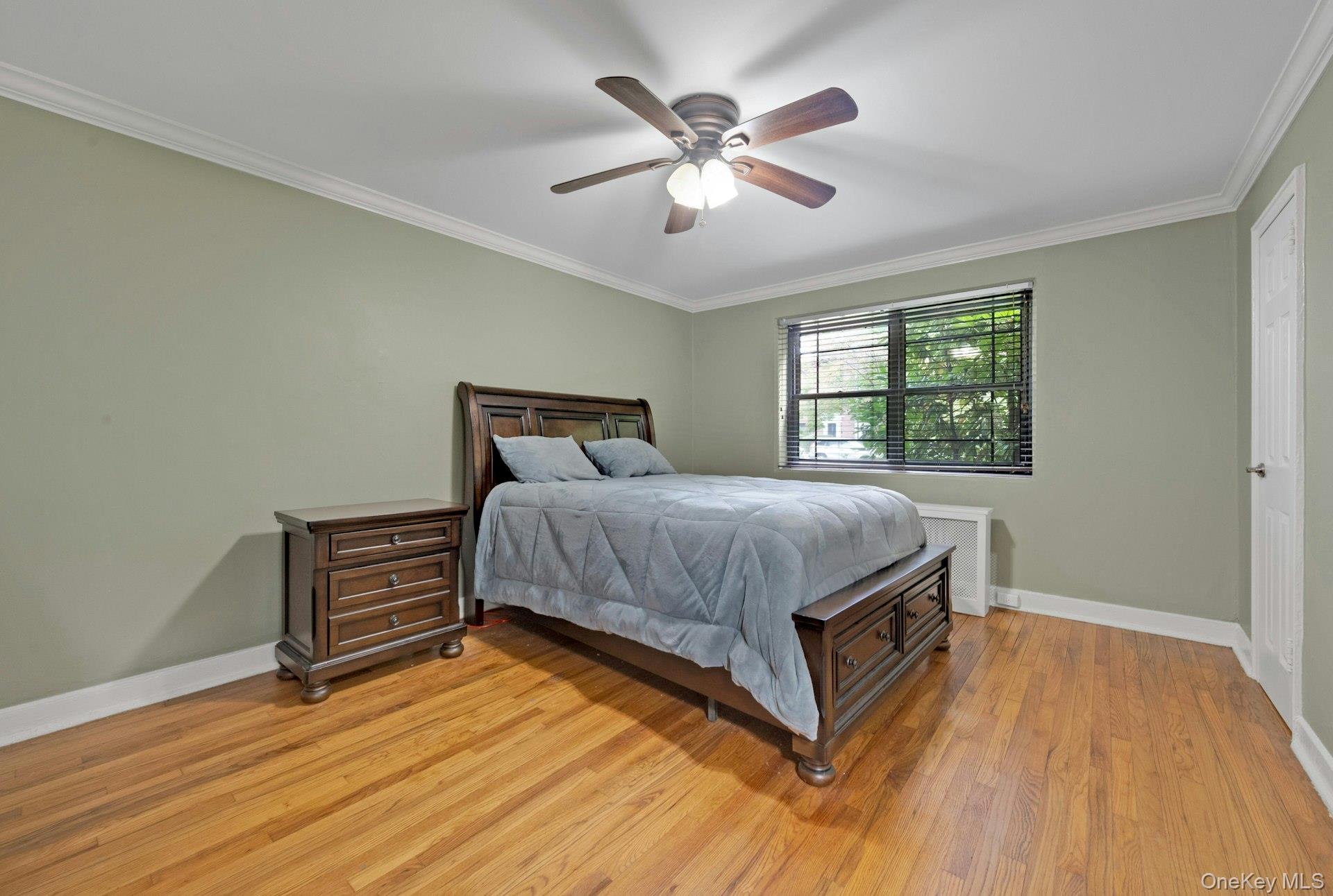 6 Manchester Road, Unit 1 Eastchester, NY 10709 - Photo 22 of 40 Bedroom with ornamental molding, light wood finished floors, and a ceiling fan
