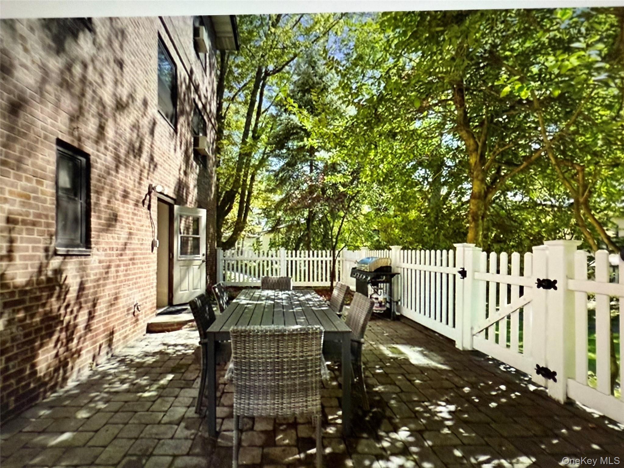 6 Manchester Road, Unit 1 Eastchester, NY 10709 - Photo 29 of 40 View of patio / terrace with outdoor dining area, a grill, a gate, and a deck