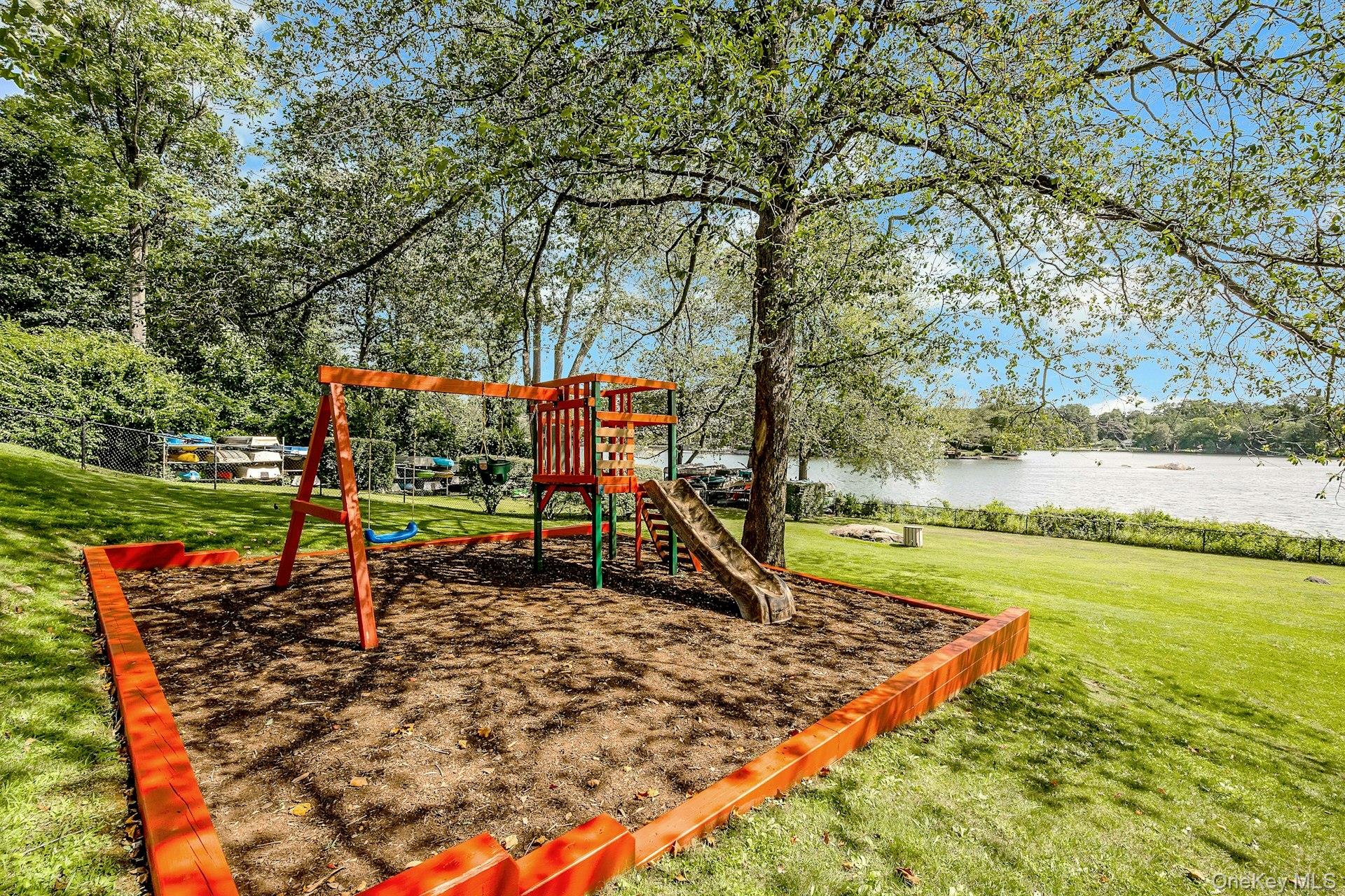 6 Manchester Road, Unit 1 Eastchester, NY 10709 - Photo 39 of 40 Community playground featuring a lawn and a water view