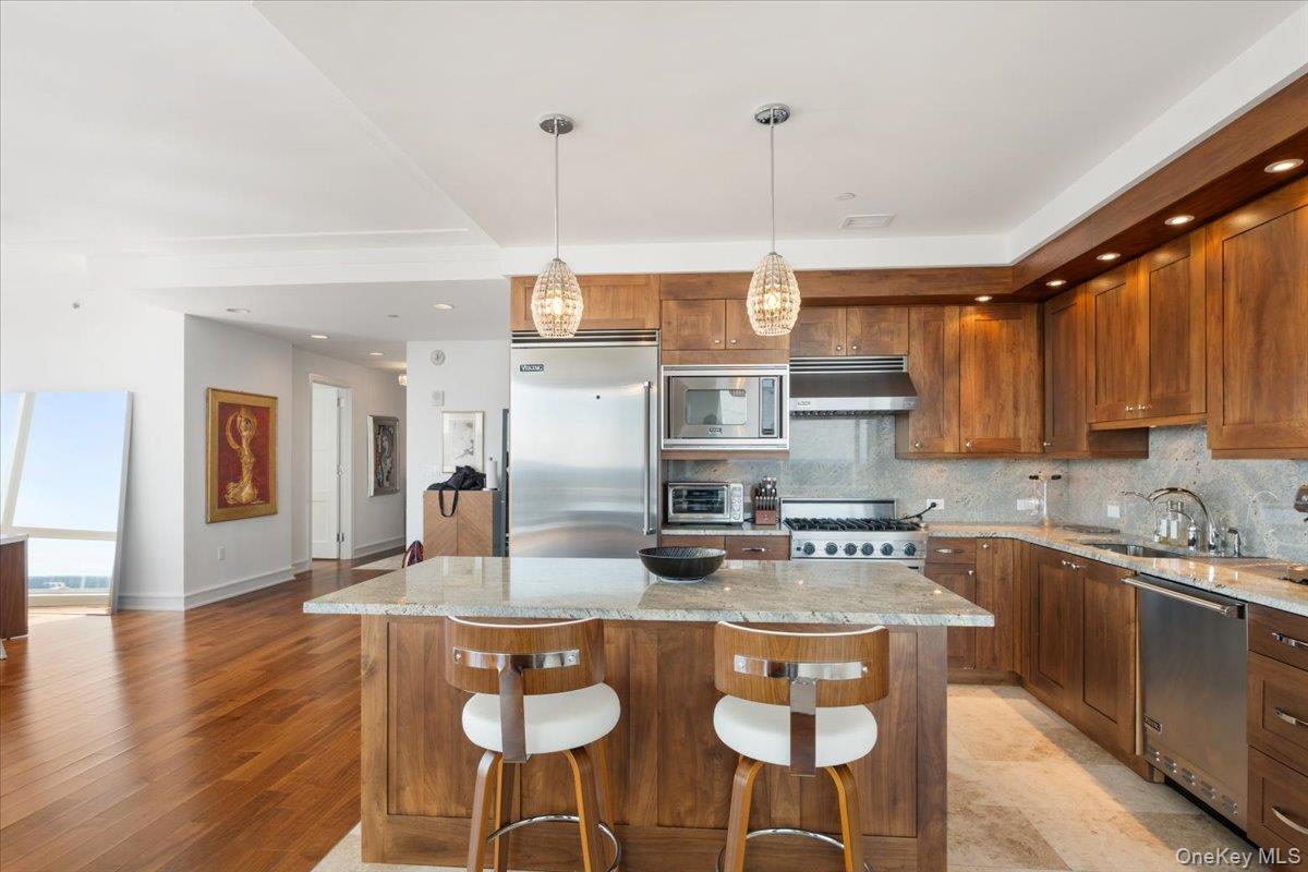 5 Renaissance Square, Unit PH 3E White Plains, NY 10601 - Photo 13 of 26 a kitchen with stainless steel appliances granite countertop a sink a stove and refrigerator