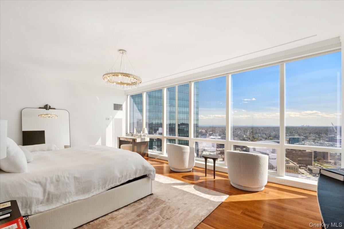5 Renaissance Square, Unit PH 3E White Plains, NY 10601 - Photo 15 of 26 a bedroom with a bed and large window
