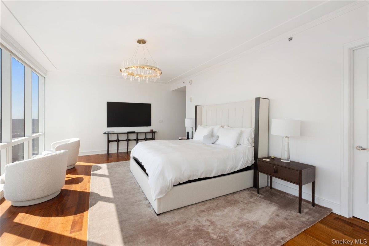 5 Renaissance Square, Unit PH 3E White Plains, NY 10601 - Photo 17 of 26 a bedroom with a bed and a flat screen tv
