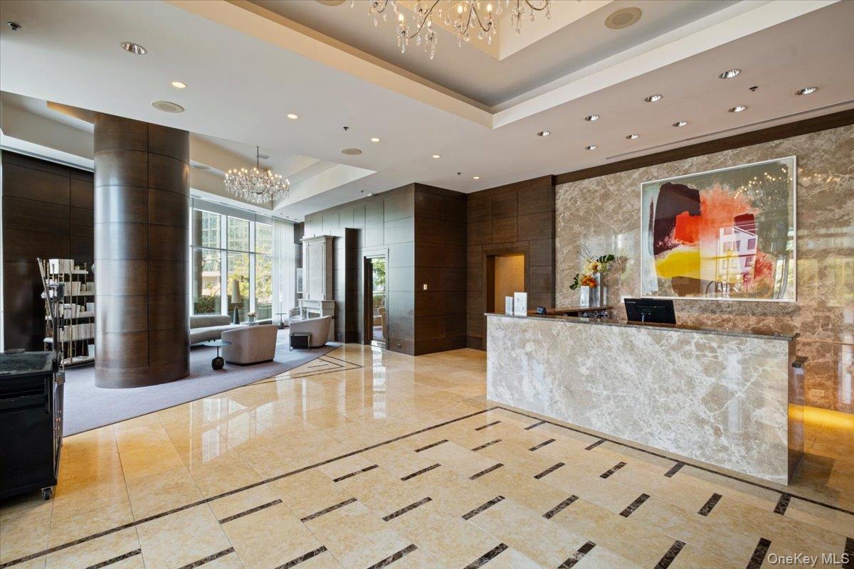 5 Renaissance Square, Unit PH 3E White Plains, NY 10601 - Photo 3 of 26 a lobby with furniture and flat screen tv