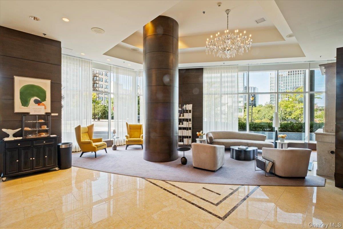 5 Renaissance Square, Unit PH 3E White Plains, NY 10601 - Photo 4 of 26 a living room with furniture and a large window